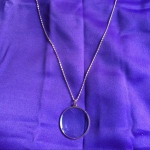 Rose gold tone magnifying glass on chain